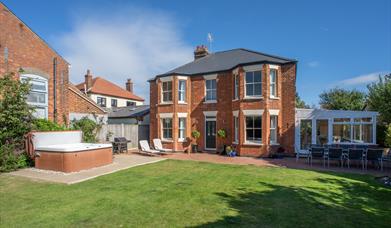 Hot tub outside with seating area and conservatory.  BBq and seating supplied