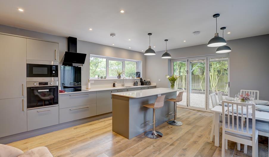 Open plan kitchen with dining table and island