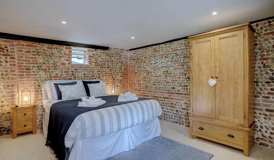 Kingsize bed showing exposed brickwork