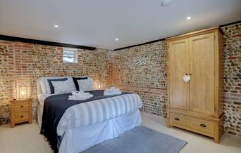 Kingsize bed showing exposed brickwork