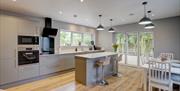 Open plan kitchen with dining table and island