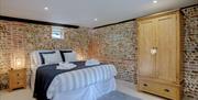 Kingsize bed showing exposed brickwork