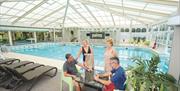 Two couples enjoy the swimming pool at Potters Resorts Hopton-on-Sea